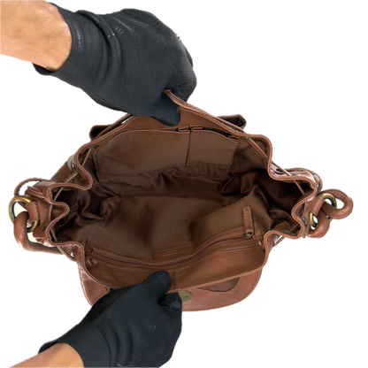 Close-up interior view of a vintage Modalu tan leather bag showing the clean lining and the authentic stitched leather Modalu brand patch.