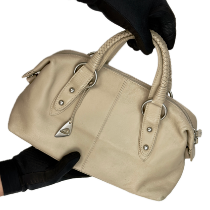 Front view of a structured vintage Y2K Tula cool beige genuine leather top handle bag with silver hardware.