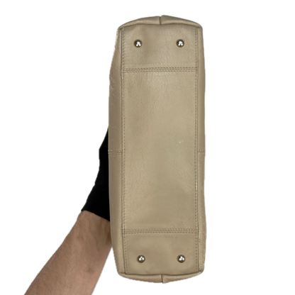 Bottom of a structured vintage Y2K Tula cool beige genuine leather top handle bag with silver hardware.