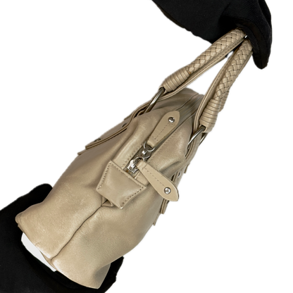 Side view of a structured vintage Y2K Tula cool beige genuine leather top handle bag with silver hardware.
