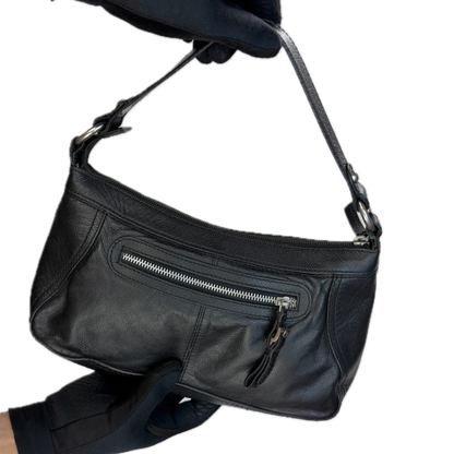 Front view of a slouchy vintage Y2K unbranded black genuine leather baguette shoulder bag featuring a front zip pocket and silver hardware.