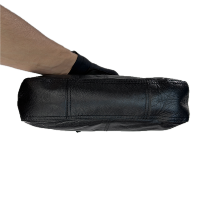 Underside view of a slouchy vintage Y2K unbranded black genuine leather baguette shoulder bag featuring a front zip pocket and silver hardware.