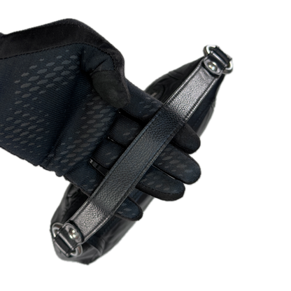 Handle of a slouchy vintage Y2K unbranded black genuine leather baguette shoulder bag featuring a front zip pocket and silver hardware.