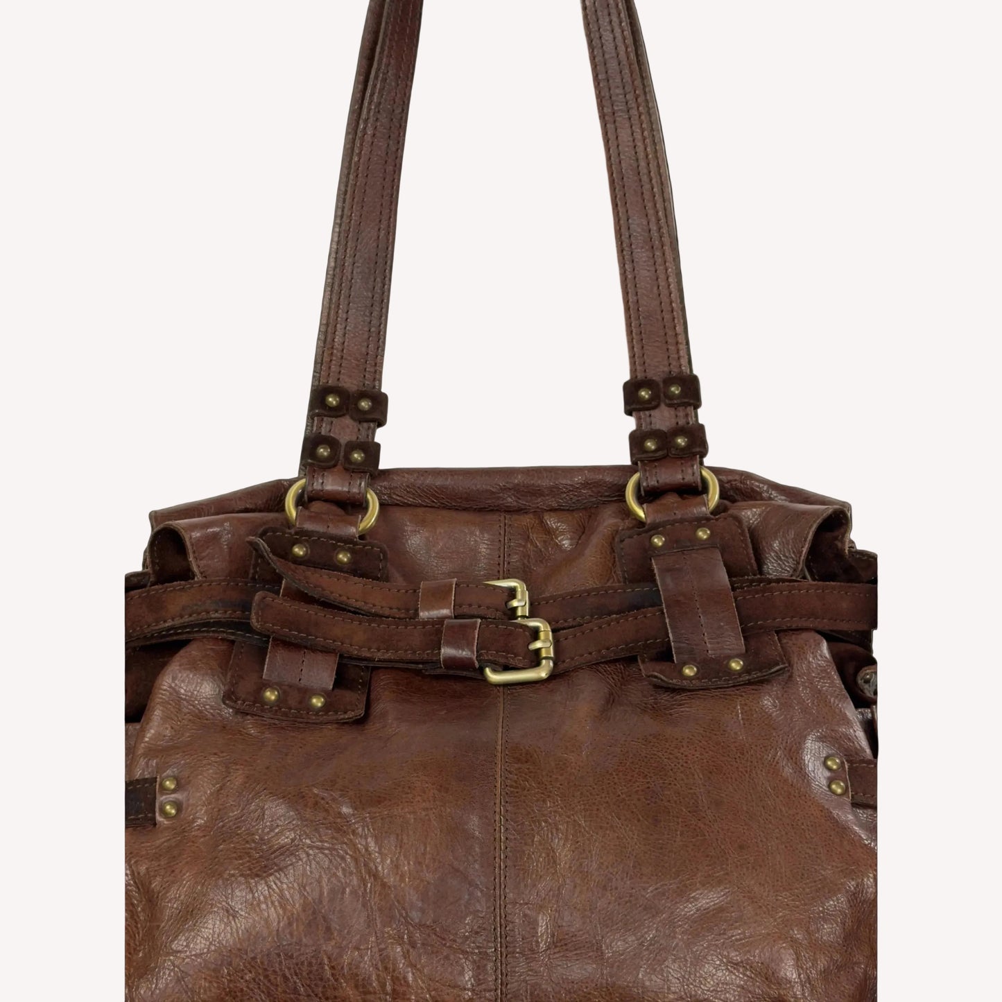 Close-up of the antique brass utilitarian hardware and distressed brown leather on a rare vintage Zippo archive bag.
