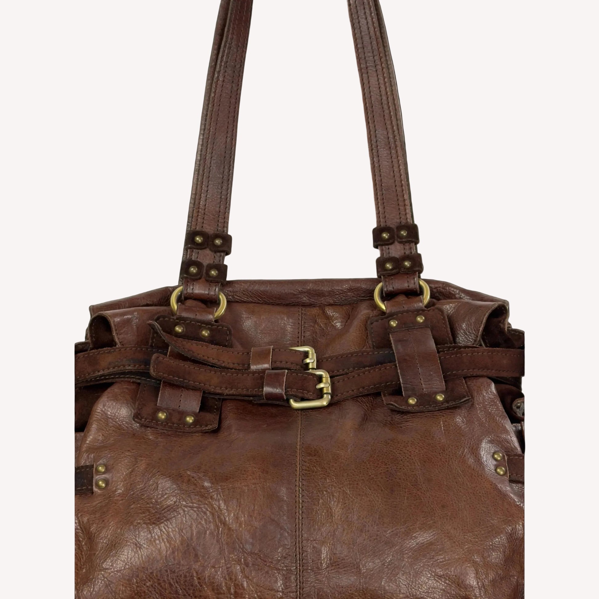 Close-up of the antique brass utilitarian hardware and distressed brown leather on a rare vintage Zippo archive bag.