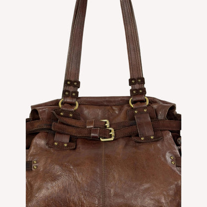 Close-up of the antique brass utilitarian hardware and distressed brown leather on a rare vintage Zippo archive bag.