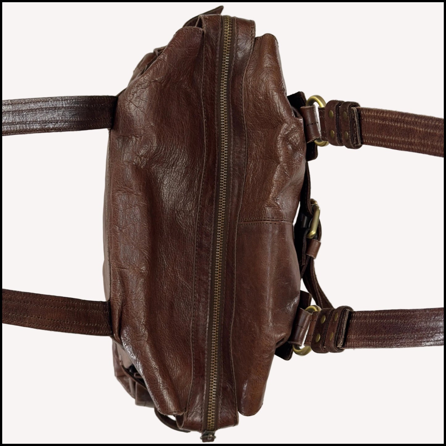 Close-up of the antique brass utilitarian hardware and distressed brown leather on a rare vintage Zippo archive bag.