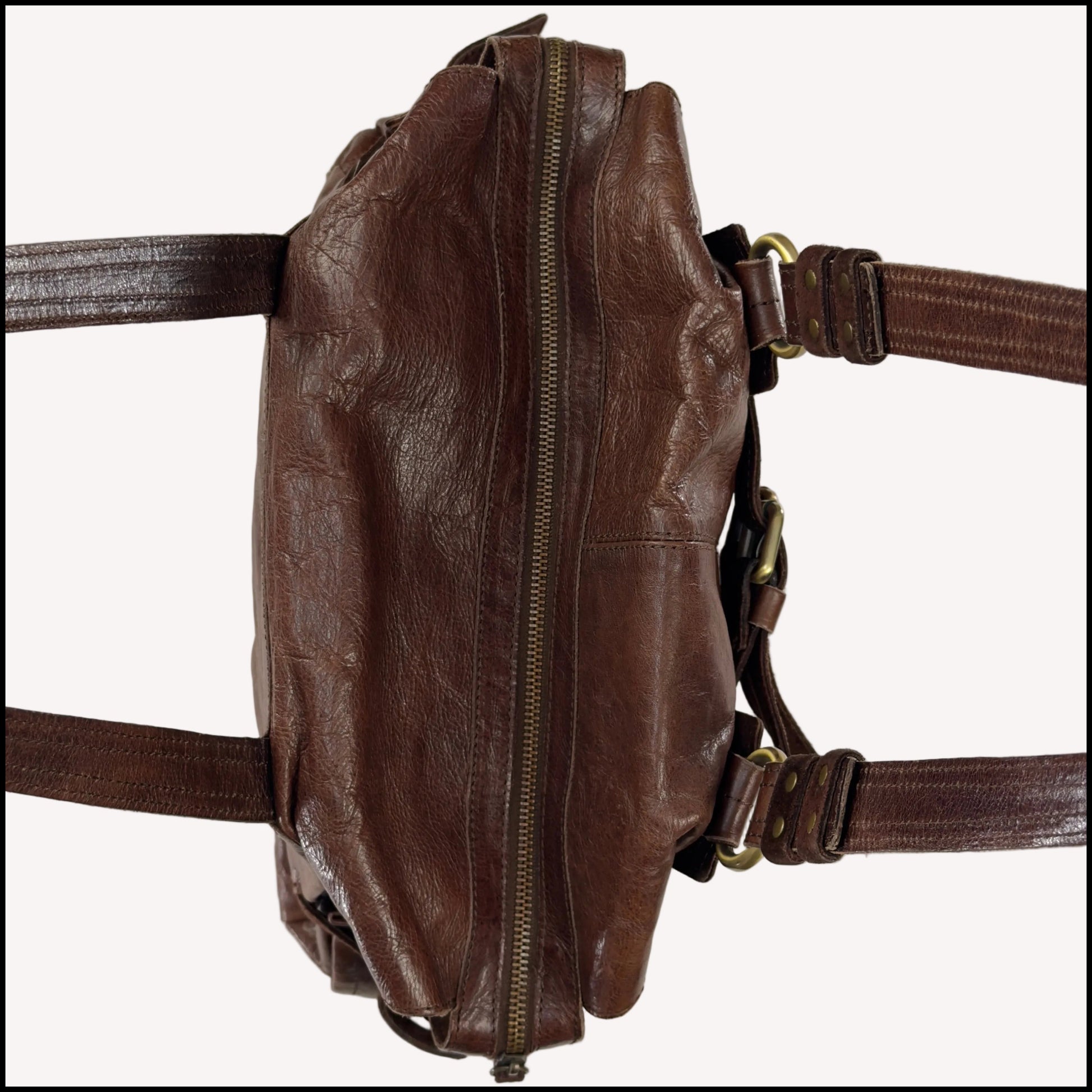 Close-up of the antique brass utilitarian hardware and distressed brown leather on a rare vintage Zippo archive bag.