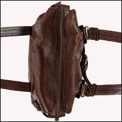 Close-up of the antique brass utilitarian hardware and distressed brown leather on a rare vintage Zippo archive bag.