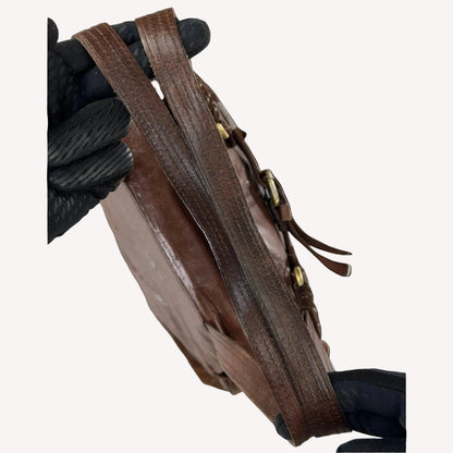 Close-up of the antique brass utilitarian hardware and distressed brown leather on a rare vintage Zippo archive bag.