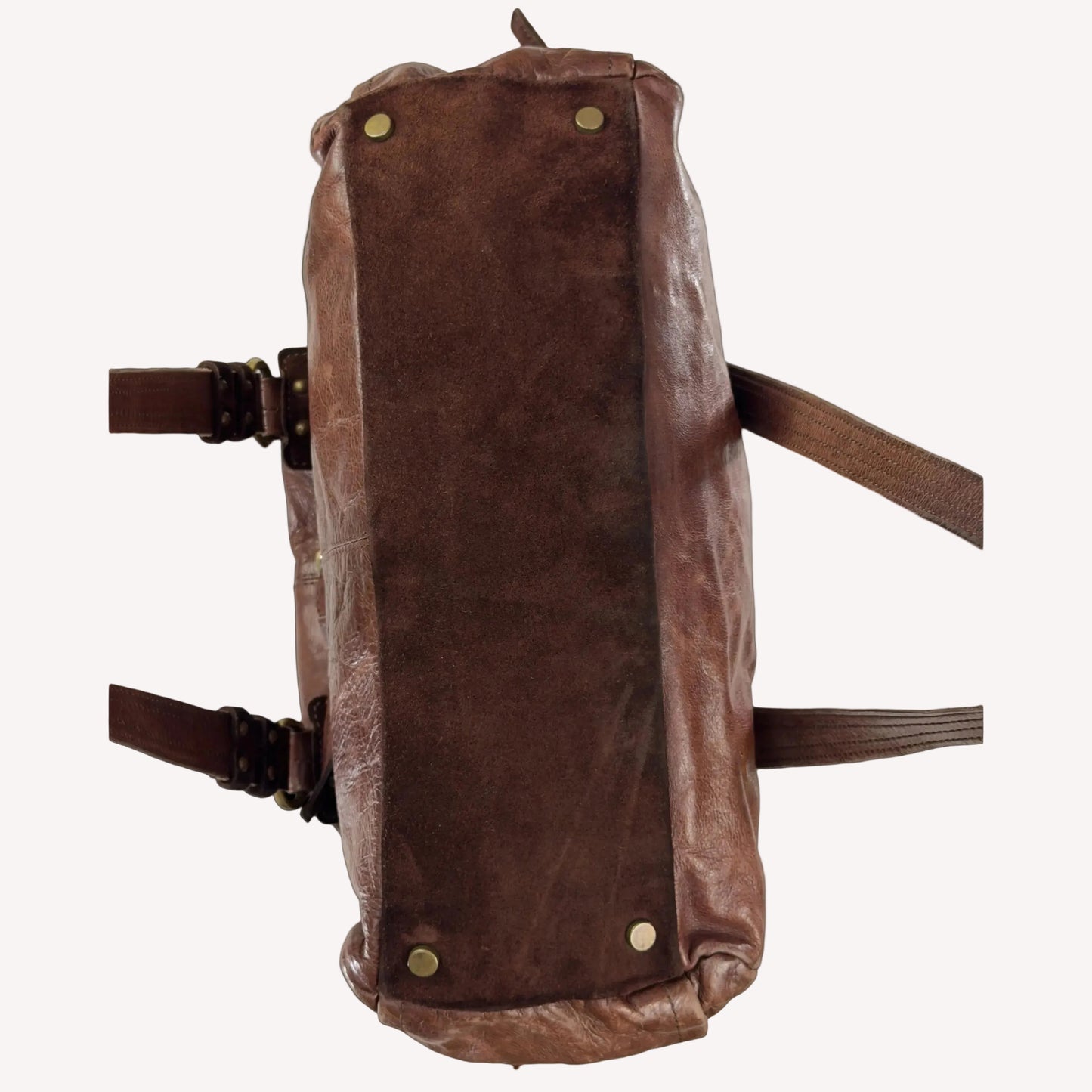 Close-up of the antique brass utilitarian hardware and distressed brown leather on a rare vintage Zippo archive bag.