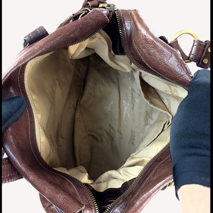 Vintage Zippo slouchy shoulder bag crafted from distressed brown crinkled leather, featuring a sturdy suede base and utilitarian antique brass hardware.